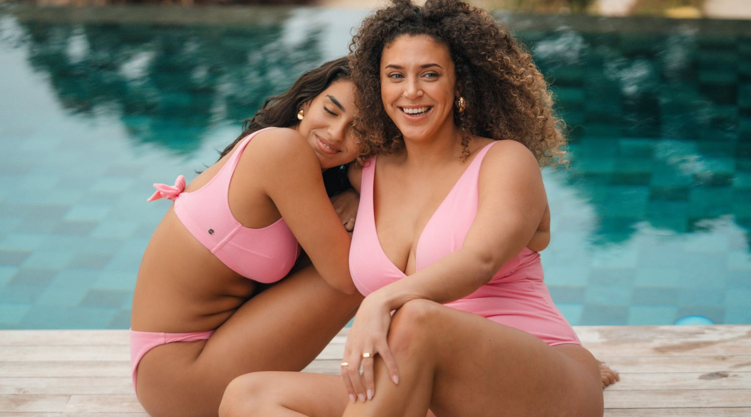 Swimwear care guide - Two women hugging, wearing pink swimwear