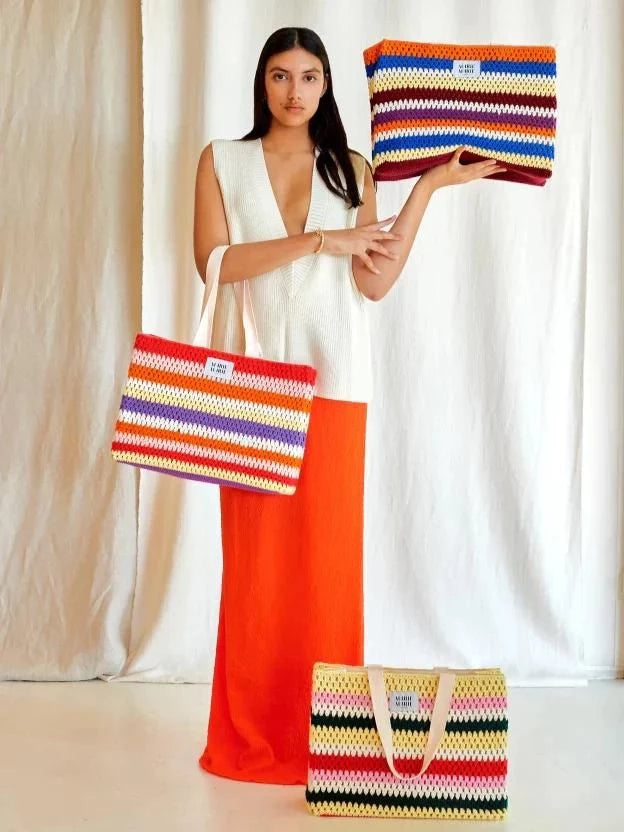 Woman with MARIE MARIE striped and colorful crochet bags