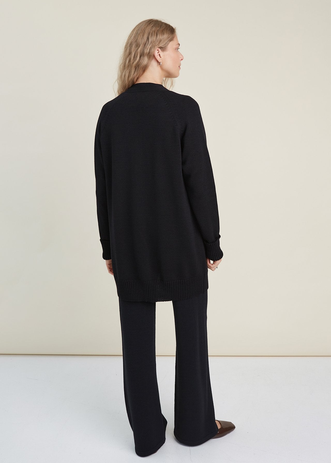 Monala black merino cardigan belted at waist, side view