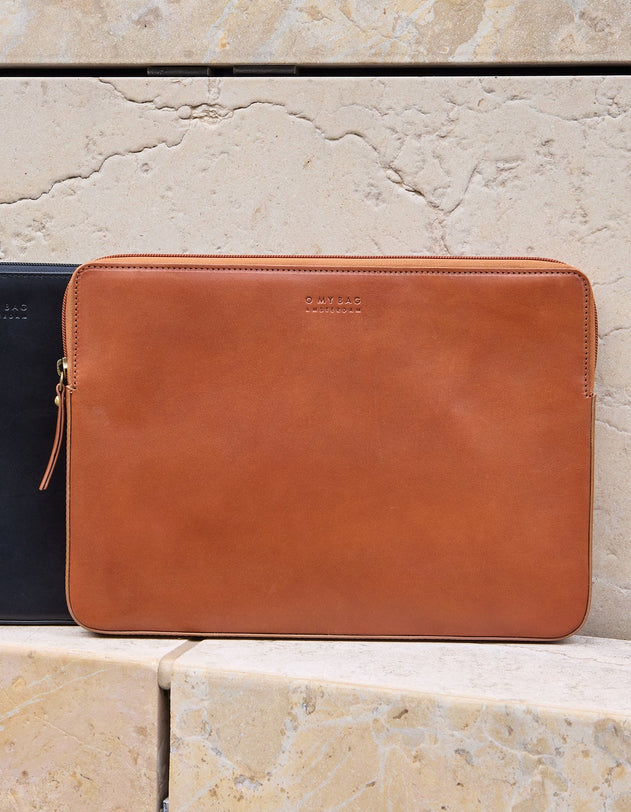 Brown leather sleeve on a stone surface