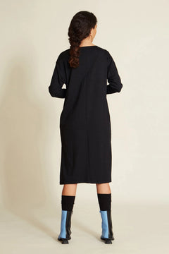 Model wearing black dress styled for everyday use