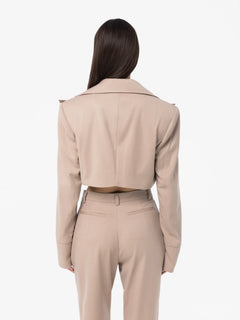 Person wearing a beige suit on a white background