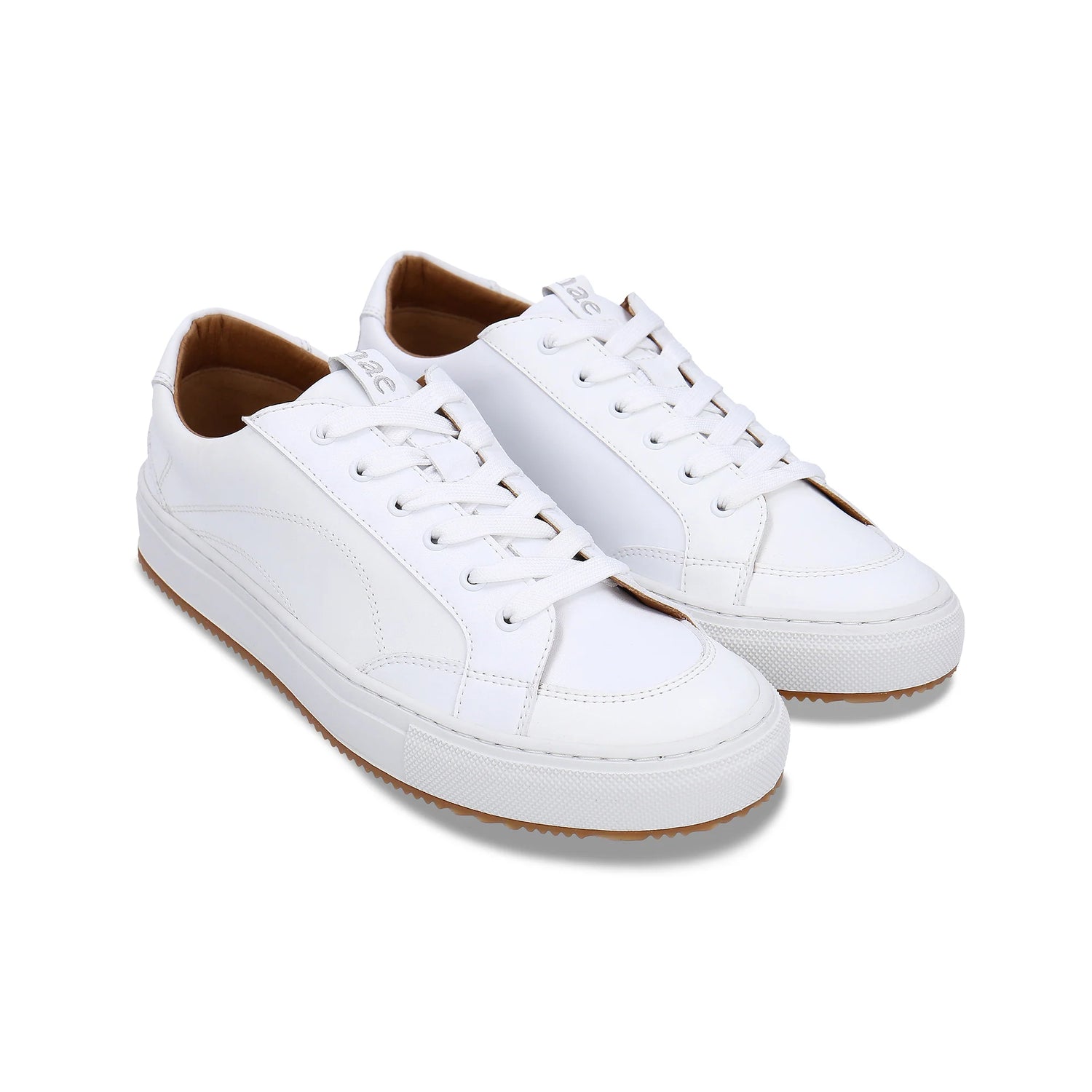 White sneakers with brown soles on a white background