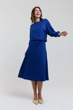 Woman wearing a blue dress on a white background