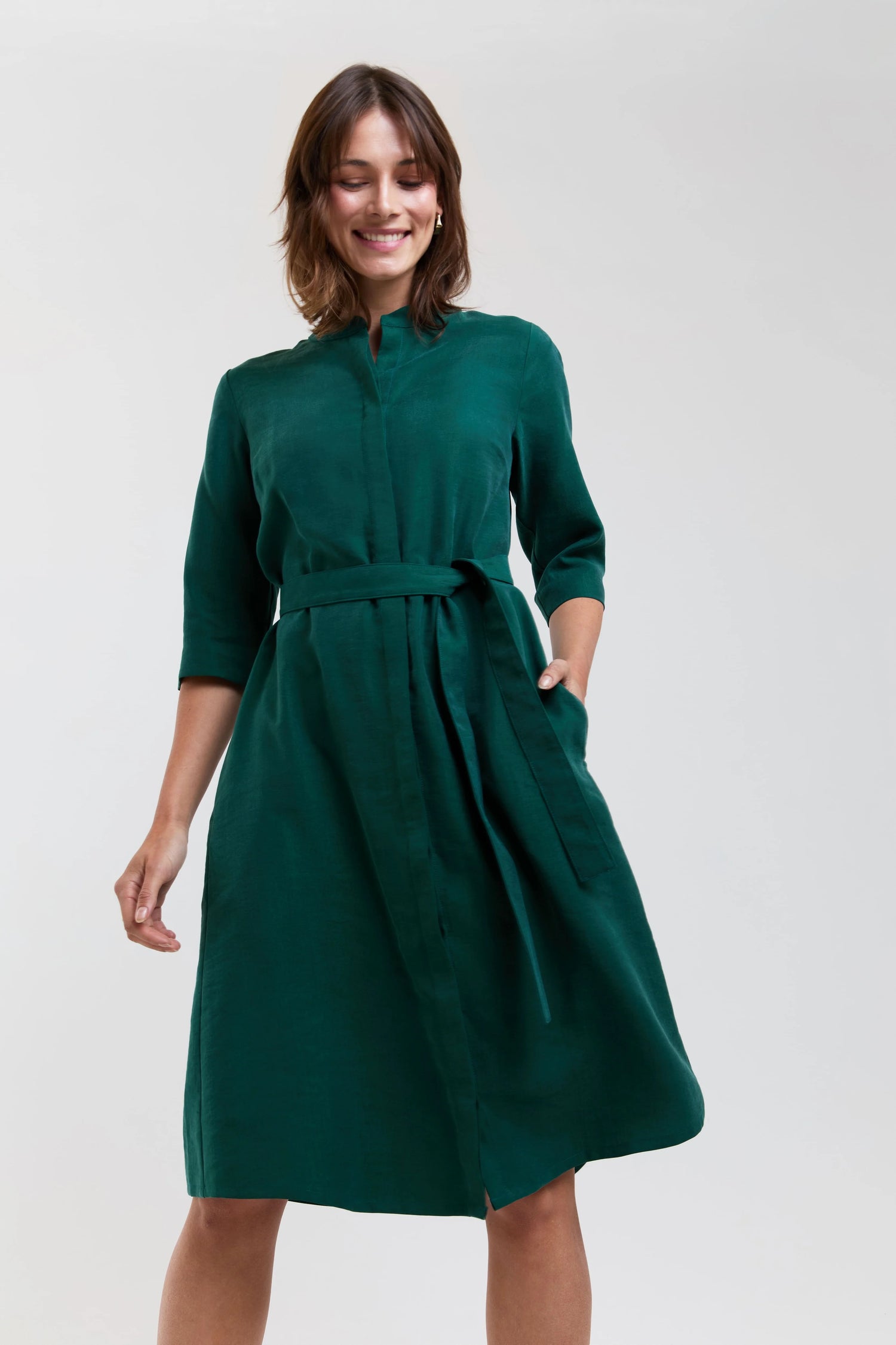 Woman wearing a green dress against a white background
