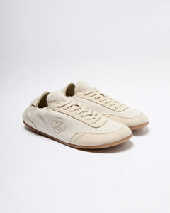 Pair of beige sneakers on a white background
