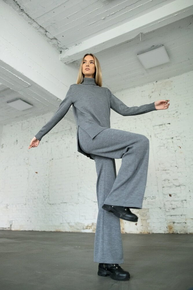 Model wearing grey merino wide-leg pants with turtleneck sweater