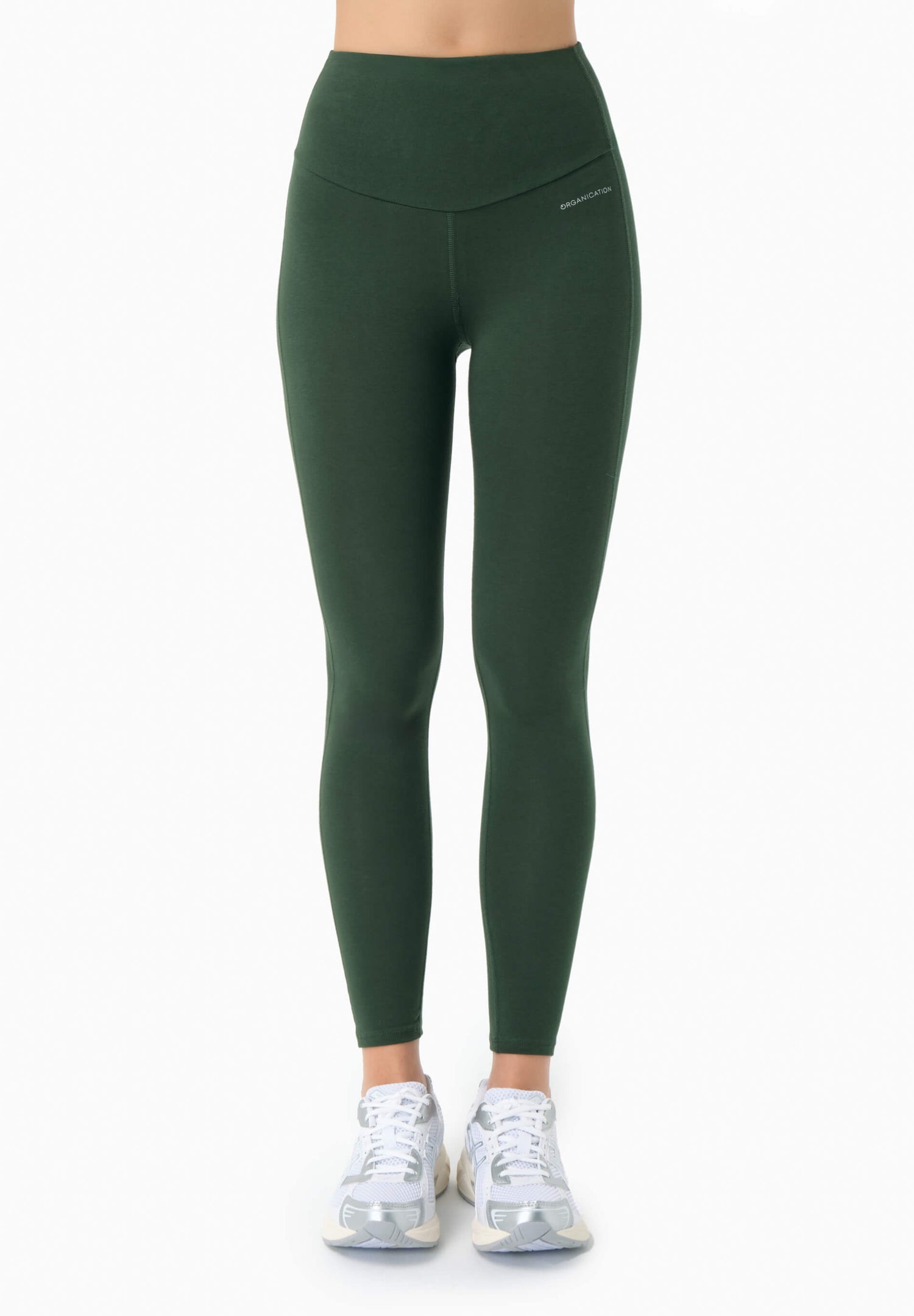 Green leggings worn by a person on a white background