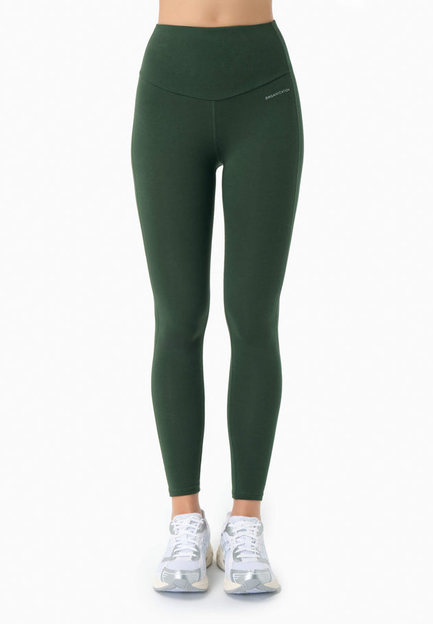 Green leggings worn by a person on a white background