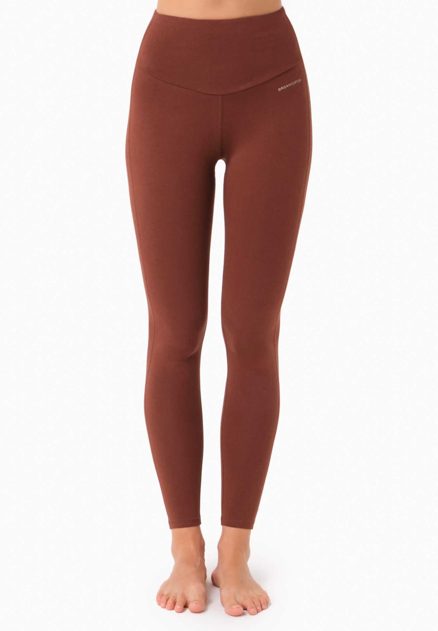 Brown leggings worn by a person on a white background