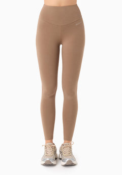 Beige leggings worn by a person on a white background