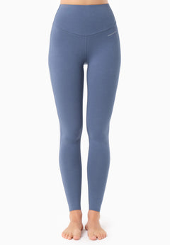 Blue leggings worn by a person on a white background