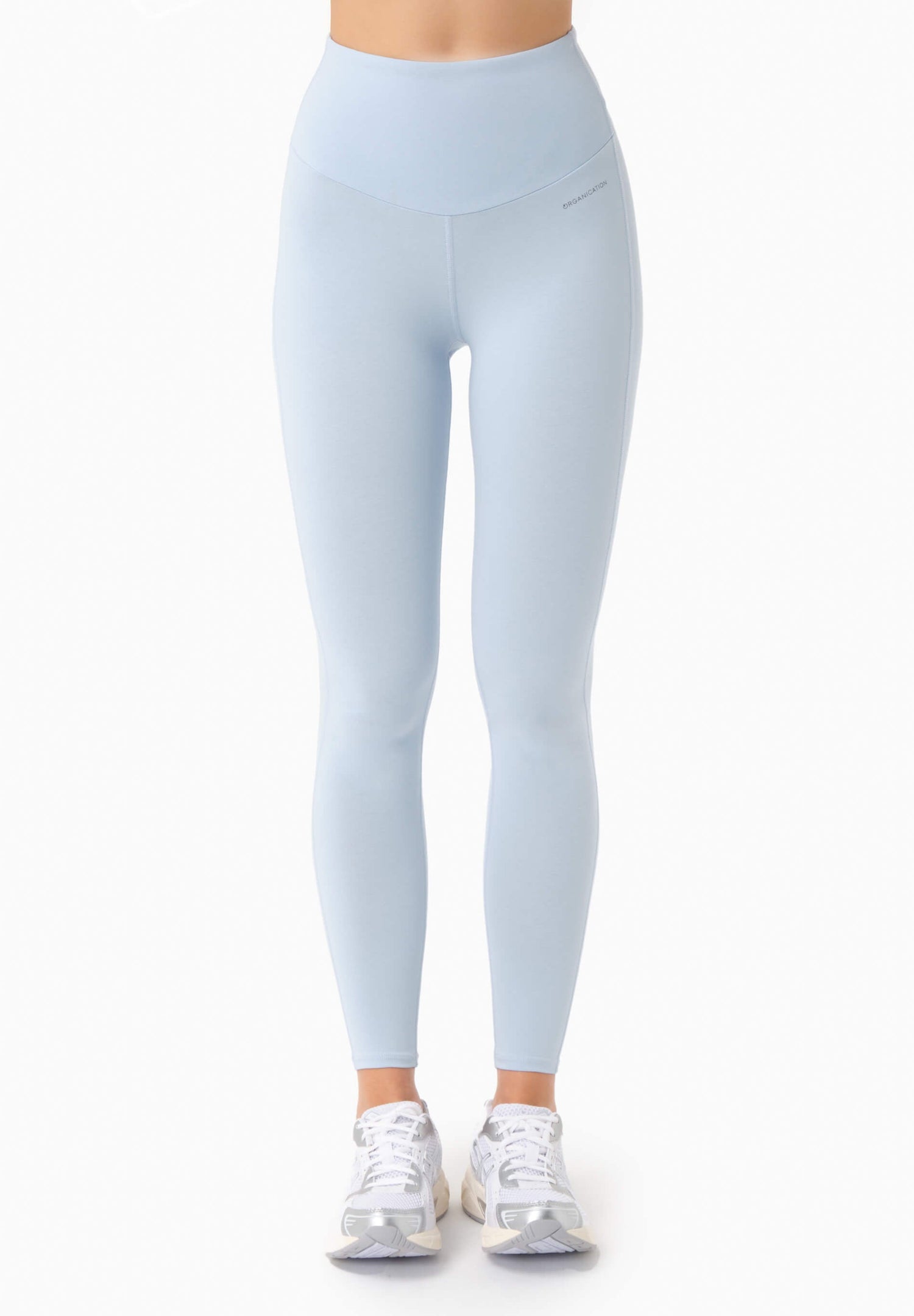 Light blue leggings worn by a person on a white background