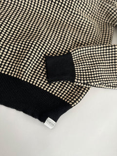 Woman wearing Komodo black and cream white organic cotton sweater